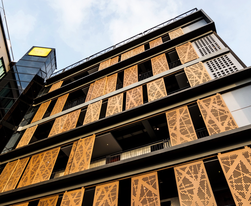 Low angle looking up at modern building with blue sky