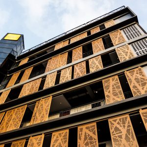 Low angle looking up at modern building with blue sky